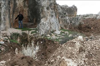 جزء من الموقع وتبدو حفرتين من الحفر التي حفرها اللصوص